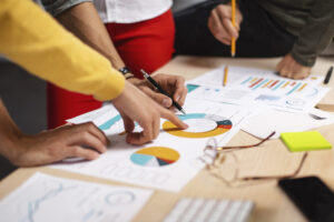 Close-up shot of a group of colleagues going through paperwork together in the office